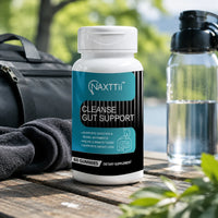 Gut cleanse supplement bottle outdoors on a wooden table with greenery